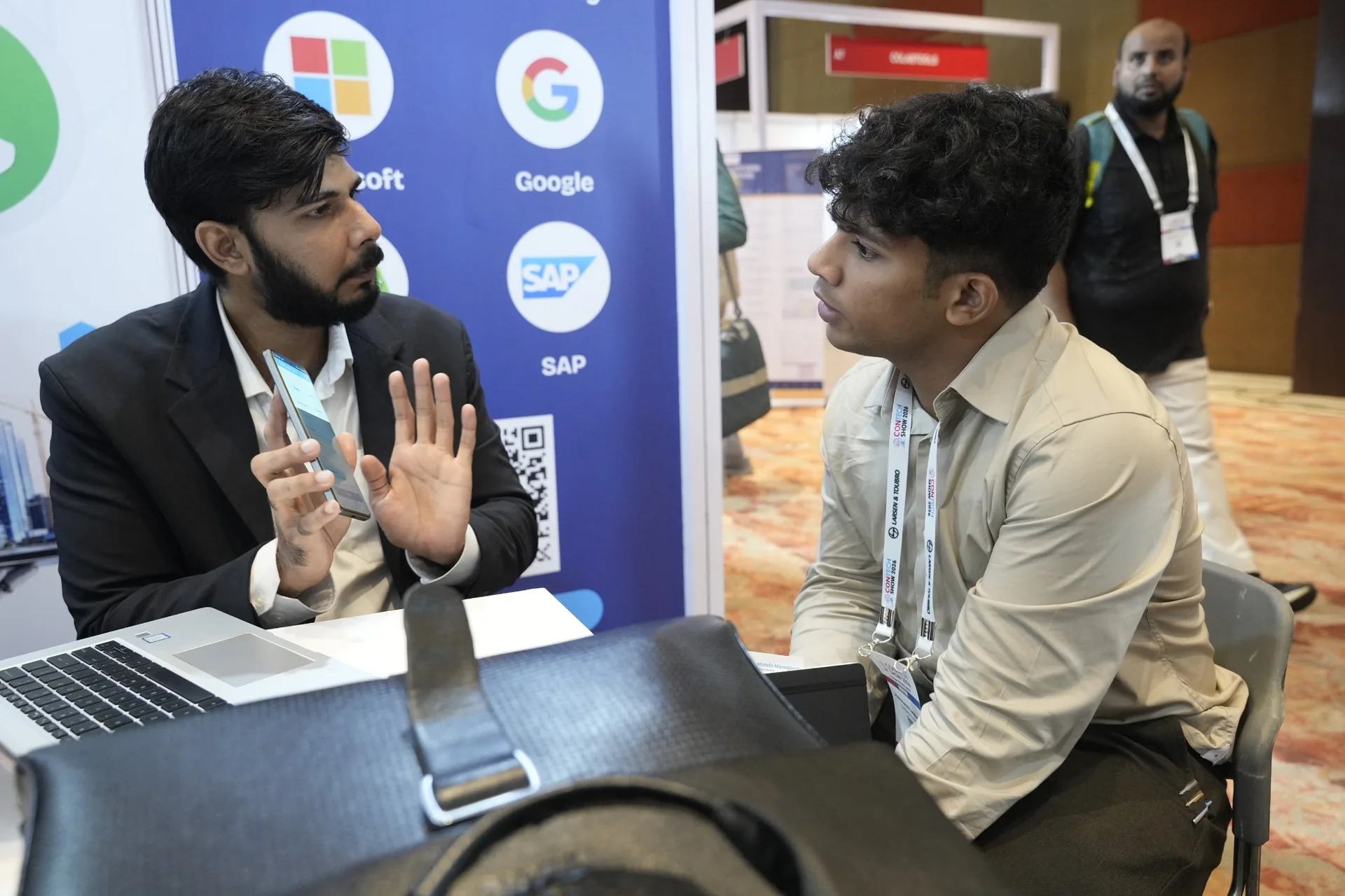 Aasaan Tech representative discussing construction management software with a visitor at CTS 2026, Mumbai